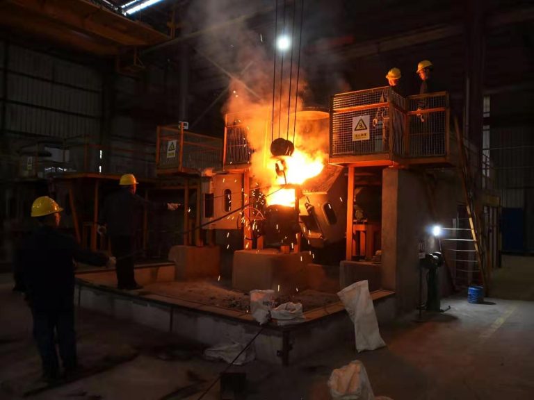 Workers pouring molten steel from ladle into molds with bright sparks flying at ZHILI foundry workshop in Luoyang, China — showcasing the steel casting manufacturing process for crusher wear parts
